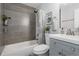 Bathroom with tiled shower, modern vanity, and stylish decor for a spa-like feel at 8559 W 75Th Pl, Arvada, CO 80005