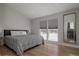 Cozy bedroom with a large window, hardwood floors, and simple furnishings at 8559 W 75Th Pl, Arvada, CO 80005