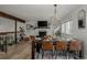 Open-concept dining area with stylish fireplace, hardwood floors, and natural light at 8559 W 75Th Pl, Arvada, CO 80005