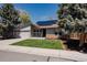 Charming home with a well-maintained lawn, complemented by solar panels at 8559 W 75Th Pl, Arvada, CO 80005
