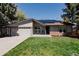 Charming single-story home with a well-manicured lawn and solar panels on the roof at 8559 W 75Th Pl, Arvada, CO 80005