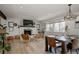 Open-concept living and dining area with stylish fireplace, hardwood floors, and natural light at 8559 W 75Th Pl, Arvada, CO 80005
