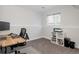 Home office with a wooden desk, ergonomic chair, and natural light from the window at 8559 W 75Th Pl, Arvada, CO 80005