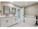 Modern bathroom featuring double vanity, a soaking tub, and stylish fixtures at 46 Douglas Dr, Broomfield, CO 80020