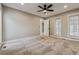 Light-filled bedroom featuring neutral carpeting, large windows, and access to a private balcony at 46 Douglas Dr, Broomfield, CO 80020