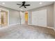 Neutral bedroom with a ceiling fan, closets, carpeted floors and an adjacent room at 46 Douglas Dr, Broomfield, CO 80020