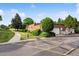 Charming exterior view of home with mature landscaping, attached garage, and brown shingle roof at 46 Douglas Dr, Broomfield, CO 80020