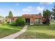 Charming single-Gathering home featuring a unique roof design, green lawn, and beautiful curb appeal at 46 Douglas Dr, Broomfield, CO 80020