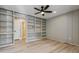 Versatile room with custom built-in shelving, offering ample storage and display space, with hardwood floors at 46 Douglas Dr, Broomfield, CO 80020