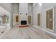 Bright living room featuring hardwood floors, a fireplace, and high ceilings, creating an airy and inviting space at 46 Douglas Dr, Broomfield, CO 80020