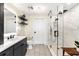 Elegant bathroom with marble shower, dark vanity, and floating shelves at 2001 Lincoln St # 3121, Denver, CO 80202