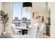 Chic dining area with modern chandelier and stunning city views through expansive windows at 2001 Lincoln St # 3121, Denver, CO 80202