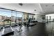 Well-equipped gym with treadmills, exercise bikes, and weight machines, featuring floor-to-ceiling windows with city views at 2001 Lincoln St # 3121, Denver, CO 80202