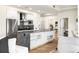 Bright kitchen featuring an island with gray countertops, white cabinets, and stainless steel appliances at 2001 Lincoln St # 3121, Denver, CO 80202