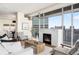 Inviting living room with fireplace and city views flowing into dining area at 2001 Lincoln St # 3121, Denver, CO 80202