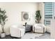 Cozy seating area with stylish chairs and plants in natural light at 2001 Lincoln St # 3121, Denver, CO 80202