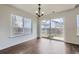 Dining room with wood floors, chandelier, large window and sliding glass door to the backyard at 20000 E Mitchell Pl # 39, Denver, CO 80249