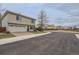Home exterior with a two-car garage, brick driveway and neutral colored siding at 20000 E Mitchell Pl # 39, Denver, CO 80249