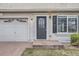 Front door and garage of a two-story home featuring a brick driveway at 20000 E Mitchell Pl # 39, Denver, CO 80249