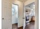 Entry way leading to a half bathroom and kitchen with stainless steel appliances at 20000 E Mitchell Pl # 39, Denver, CO 80249