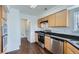Updated kitchen boasts stainless steel appliances, wood cabinets, and dark countertops at 20000 E Mitchell Pl # 39, Denver, CO 80249