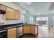 Kitchen with stainless steel dishwasher, black countertops, cabinets, and wood floors at 20000 E Mitchell Pl # 39, Denver, CO 80249