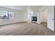 Spacious living room with a cozy fireplace and abundant natural light at 20000 E Mitchell Pl # 39, Denver, CO 80249