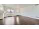 Living room with wood floors and white walls with a window and white door at 20000 E Mitchell Pl # 39, Denver, CO 80249