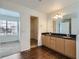 Well-lit main bathroom with dual sinks, closet, and access to a bedroom at 20000 E Mitchell Pl # 39, Denver, CO 80249
