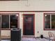 Inviting back entrance with well-maintained door, framed by windows, and featuring a 'welcome' mat at 1935 W 102Nd Ave, Thornton, CO 80260