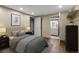 Neutral-toned bedroom showcasing modern furniture and a bathroom view at 1935 W 102Nd Ave, Thornton, CO 80260