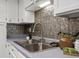 Close up of sink and faucet with decorative tile backsplash. Stylish touches throughout at 1935 W 102Nd Ave, Thornton, CO 80260
