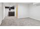 Finished basement featuring wet bar with black cabinets and carpet flooring at 17040 Numa Pl, Parker, CO 80134