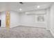 Open basement space with neutral carpeting, a window and a walk-in shower at 17040 Numa Pl, Parker, CO 80134
