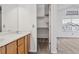 Bright bathroom features double sinks, neutral countertop, and a walk-in closet with ample storage at 17040 Numa Pl, Parker, CO 80134