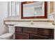 Bathroom featuring vanity with a framed mirror, tiled backsplash, and modern fixtures at 17040 Numa Pl, Parker, CO 80134