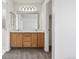 Double sink vanity with cabinets and updated lighting fixture in the bathroom at 17040 Numa Pl, Parker, CO 80134
