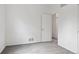 Clean, neutral bedroom space with a single door to the hallway and neutral-toned carpet at 17040 Numa Pl, Parker, CO 80134