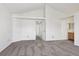 Bedroom featuring vaulted ceilings, gray carpet, and access to the bathroom at 17040 Numa Pl, Parker, CO 80134