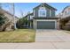 Charming two-story home features a well-maintained lawn and a convenient two-car garage at 17040 Numa Pl, Parker, CO 80134