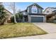 Charming two-story home boasts a well-maintained lawn and a convenient two-car garage at 17040 Numa Pl, Parker, CO 80134