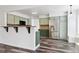 Modern kitchen features stainless appliances, beautiful backsplash, and hardwood floors at 17040 Numa Pl, Parker, CO 80134