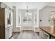 Charming breakfast nook boasts a built-in bench, stainless refrigerator, and hardwood floors at 17040 Numa Pl, Parker, CO 80134