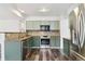Modern kitchen features stainless appliances, beautiful backsplash, and hardwood floors at 17040 Numa Pl, Parker, CO 80134