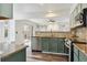 Modern kitchen features stainless appliances, beautiful backsplash, and hardwood floors at 17040 Numa Pl, Parker, CO 80134
