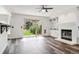 Bright living room featuring a fireplace, backyard access, and modern flooring at 17040 Numa Pl, Parker, CO 80134