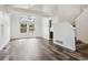 Bright living room features soaring ceilings, large windows, and stunning hardwood floors at 17040 Numa Pl, Parker, CO 80134