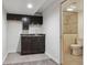 Basement wet bar complete with wine storage and nearby bathroom with shower at 17040 Numa Pl, Parker, CO 80134
