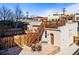 Private backyard featuring a patio with outdoor seating, wooden fence, and staircase leading to the rooftop deck at 2508 Kensing Ct, Denver, CO 80211