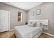 Bright bedroom with hardwood floors, white trim, and a comfortable bed, creating a peaceful retreat at 2508 Kensing Ct, Denver, CO 80211
